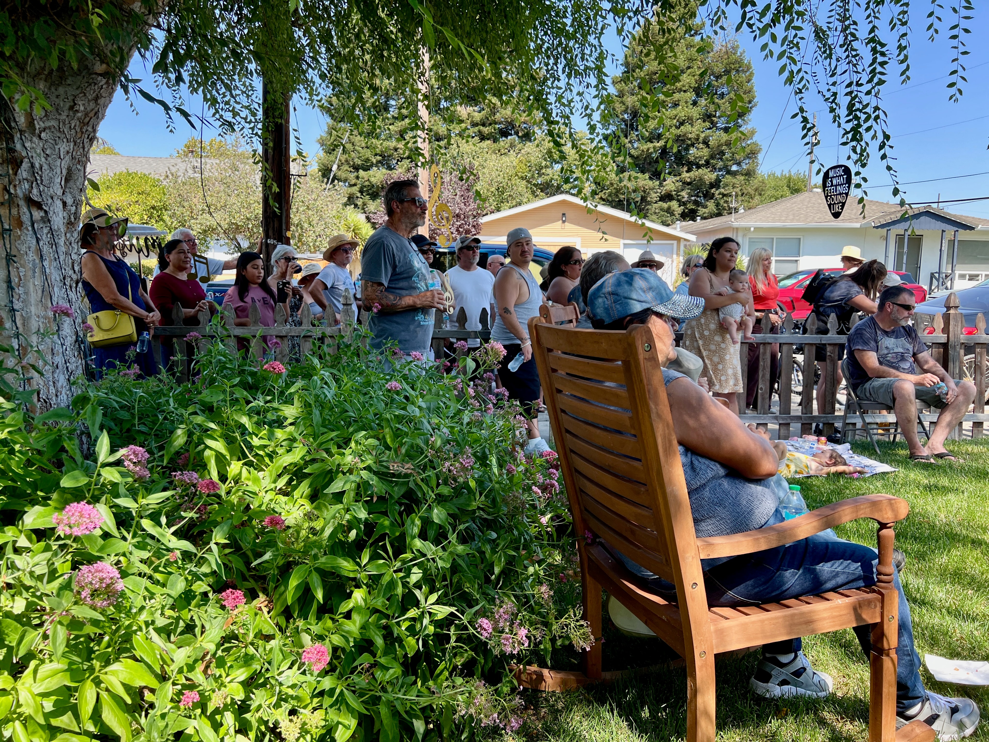 Community crowd watching live music on a lawn