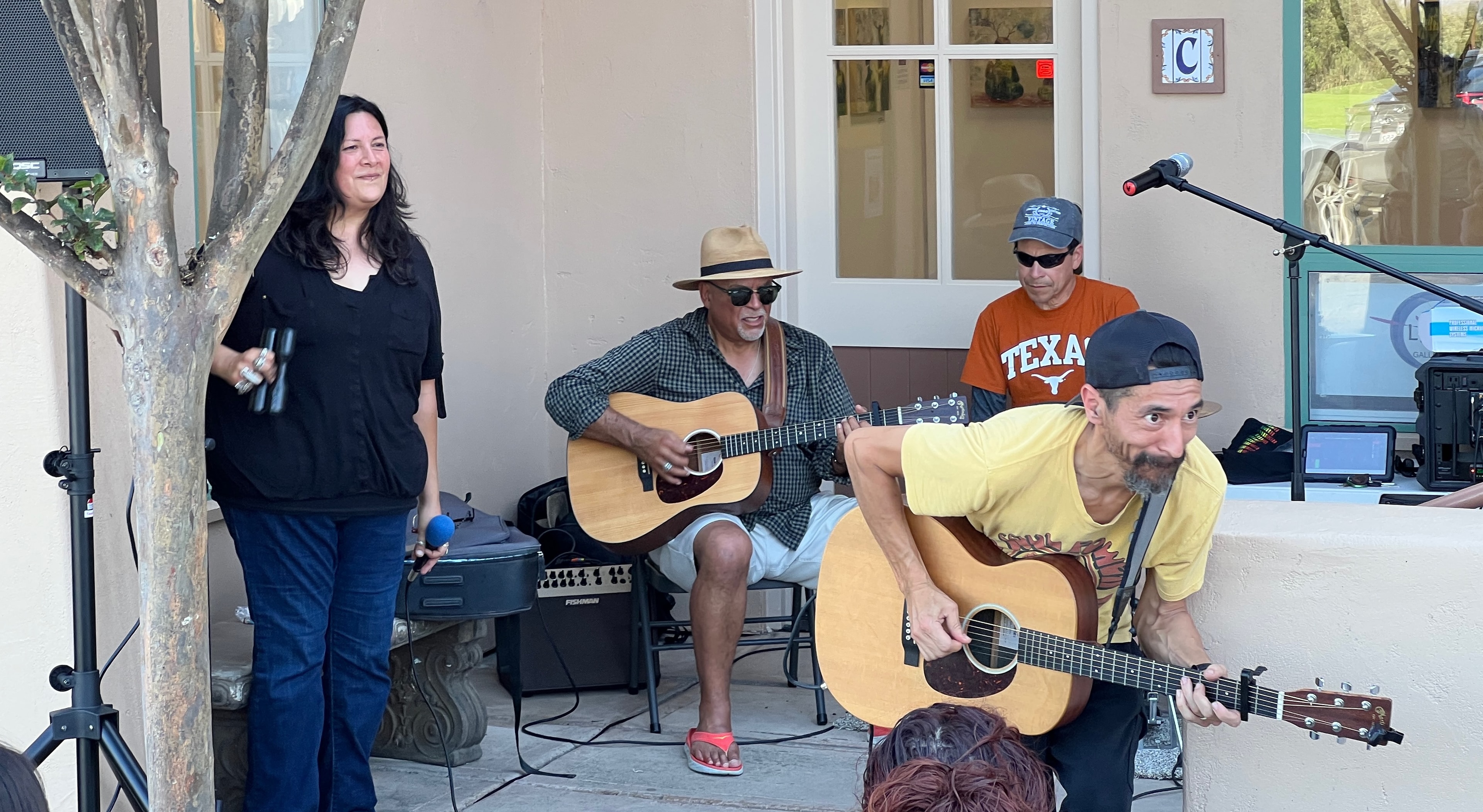 Band performing acoustic set outside Luna Gallery